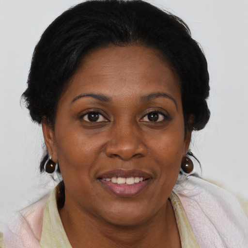 Joyful black adult female with long  brown hair and brown eyes