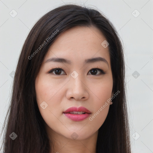 Joyful asian young-adult female with long  brown hair and brown eyes