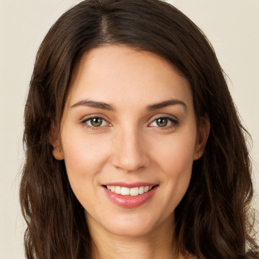 Joyful white young-adult female with long  brown hair and brown eyes