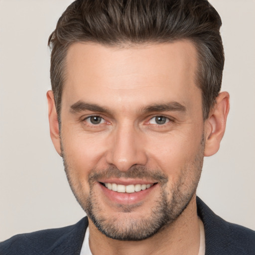 Joyful white young-adult male with short  brown hair and brown eyes