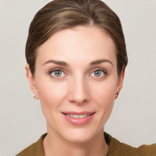 Joyful white young-adult female with short  brown hair and grey eyes