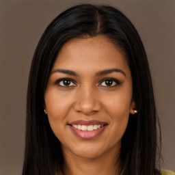 Joyful black young-adult female with long  brown hair and brown eyes