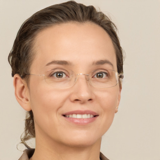 Joyful white adult female with short  brown hair and grey eyes