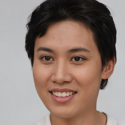 Joyful asian young-adult female with short  brown hair and brown eyes