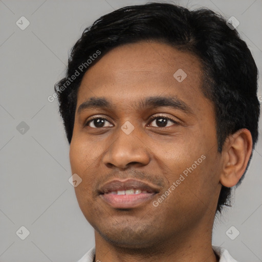 Joyful black young-adult male with short  black hair and brown eyes