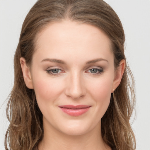 Joyful white young-adult female with long  brown hair and grey eyes