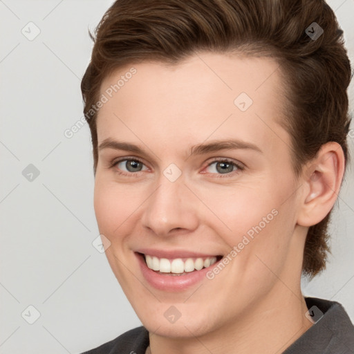 Joyful white young-adult female with short  brown hair and grey eyes