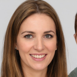 Joyful white young-adult female with long  brown hair and green eyes