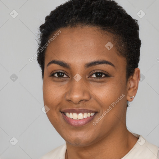 Joyful black young-adult female with short  brown hair and brown eyes