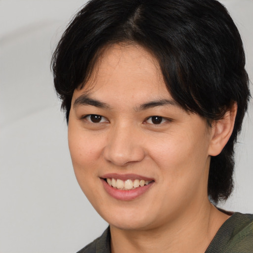 Joyful asian young-adult female with medium  brown hair and brown eyes