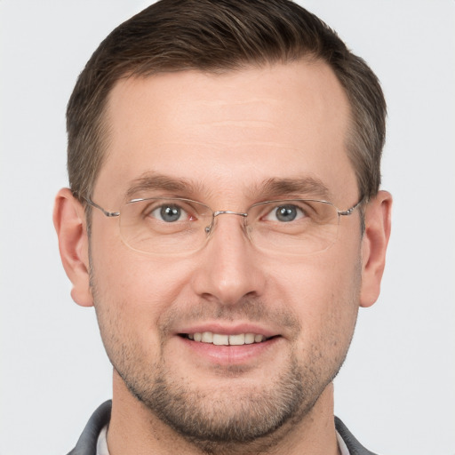 Joyful white adult male with short  brown hair and grey eyes