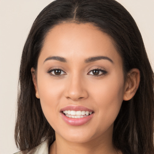 Joyful white young-adult female with long  brown hair and brown eyes