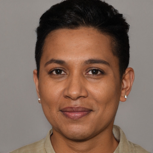 Joyful latino adult female with short  black hair and brown eyes