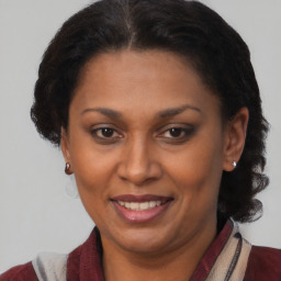 Joyful black adult female with medium  brown hair and brown eyes