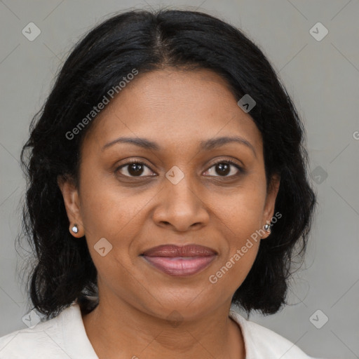 Joyful black adult female with medium  brown hair and brown eyes