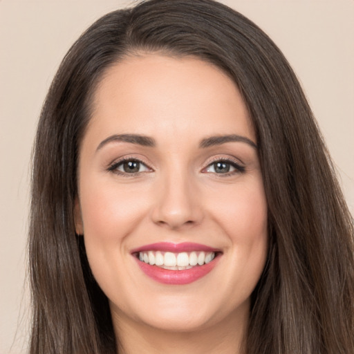 Joyful white young-adult female with long  brown hair and brown eyes