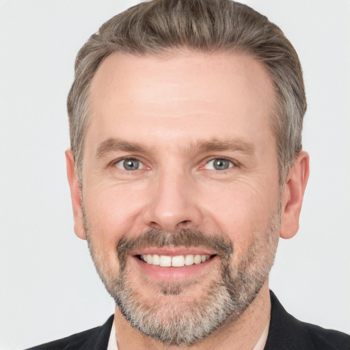 Joyful white adult male with short  brown hair and grey eyes