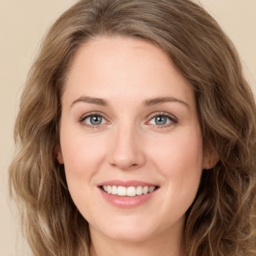 Joyful white young-adult female with long  brown hair and green eyes