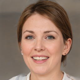 Joyful white adult female with medium  brown hair and grey eyes