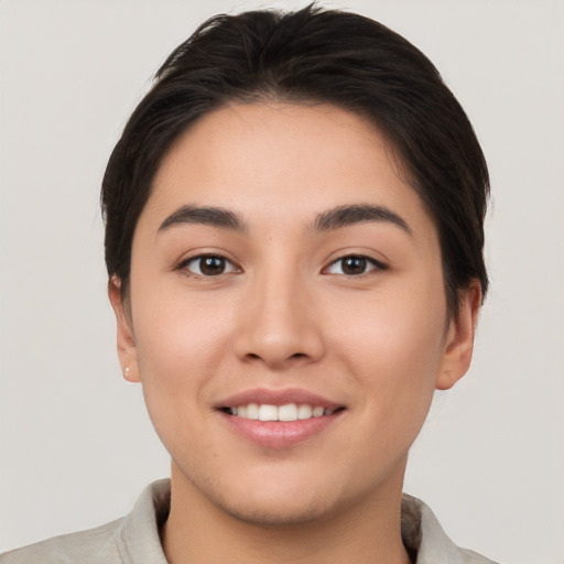 Joyful white young-adult female with short  brown hair and brown eyes