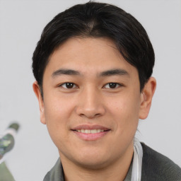 Joyful asian young-adult male with short  brown hair and brown eyes