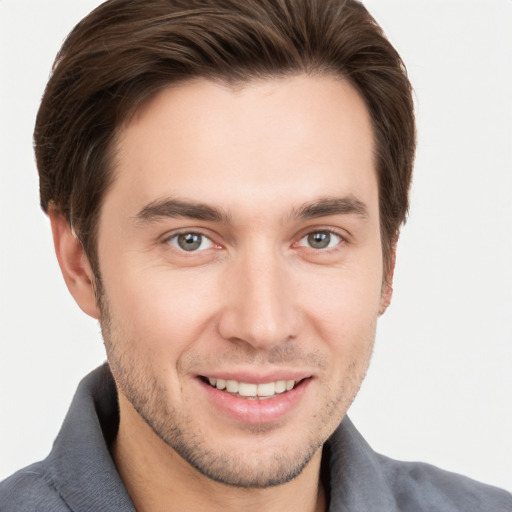 Joyful white young-adult male with short  brown hair and brown eyes