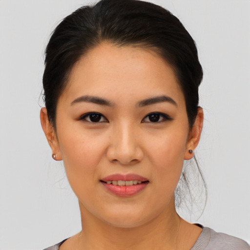 Joyful asian young-adult female with medium  black hair and brown eyes