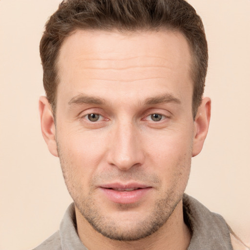 Joyful white adult male with short  brown hair and grey eyes