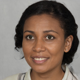 Joyful black young-adult female with medium  brown hair and brown eyes