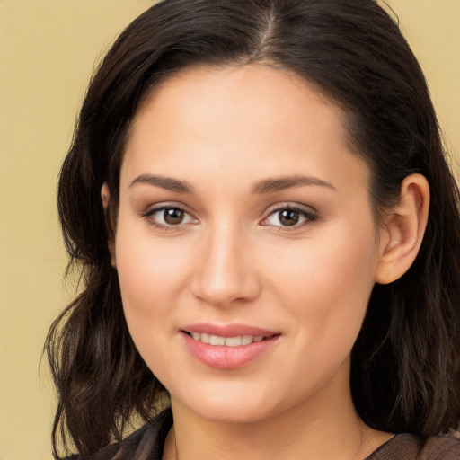 Joyful white young-adult female with long  brown hair and brown eyes