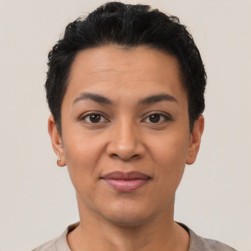 Joyful latino young-adult female with short  black hair and brown eyes