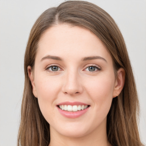 Joyful white young-adult female with long  brown hair and grey eyes