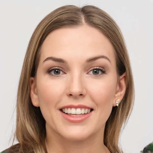 Joyful white young-adult female with long  brown hair and green eyes