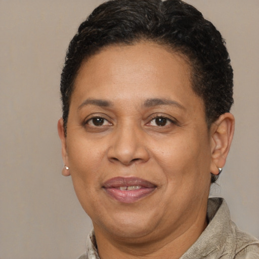 Joyful black adult female with short  brown hair and brown eyes
