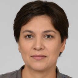 Joyful white adult female with short  brown hair and brown eyes