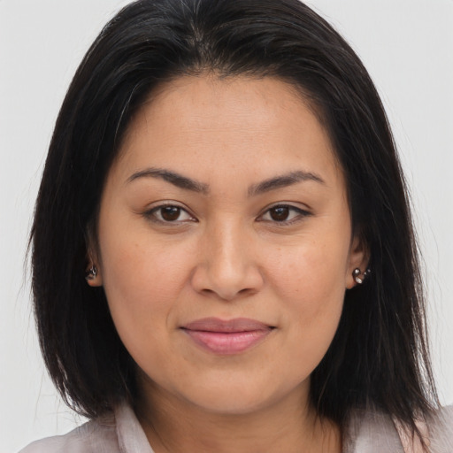 Joyful latino young-adult female with long  brown hair and brown eyes