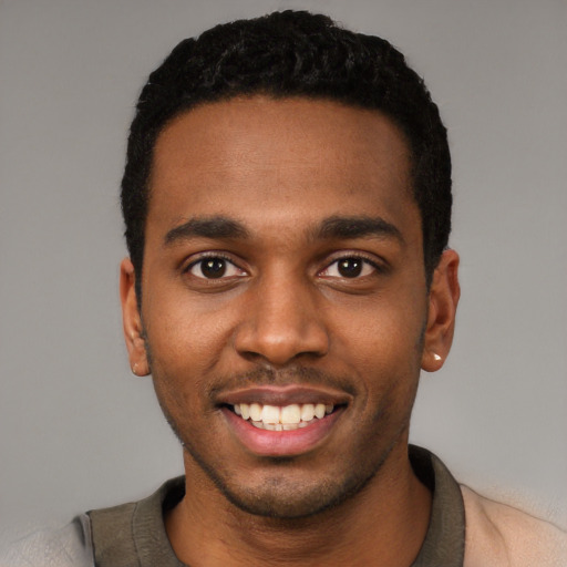 Joyful black young-adult male with short  black hair and brown eyes