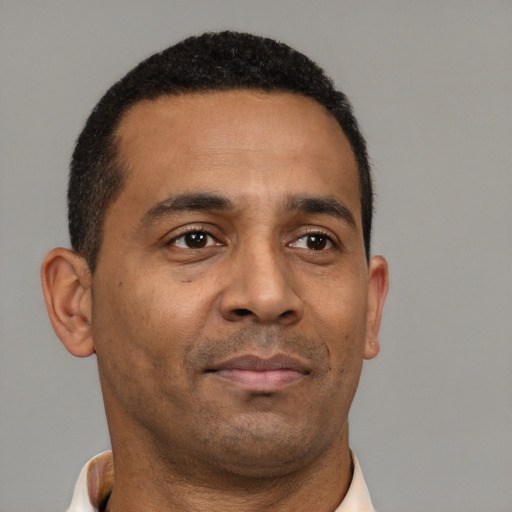 Neutral latino adult male with short  brown hair and brown eyes