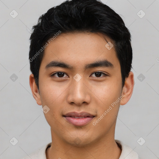 Joyful asian young-adult male with short  black hair and brown eyes