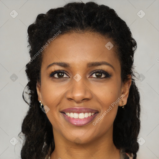 Joyful black young-adult female with long  black hair and brown eyes