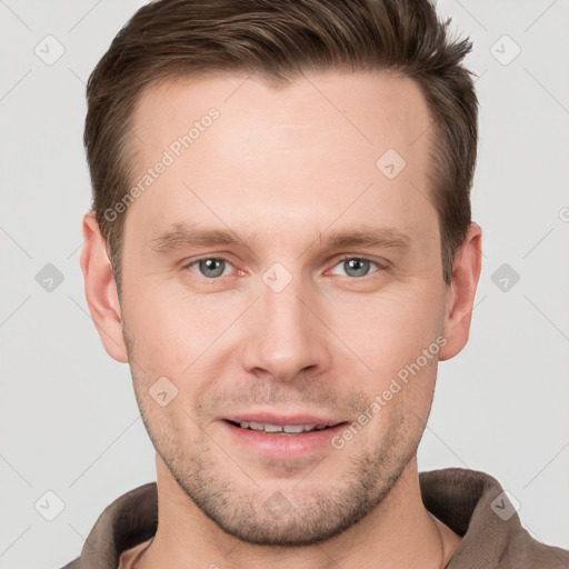 Joyful white young-adult male with short  brown hair and grey eyes