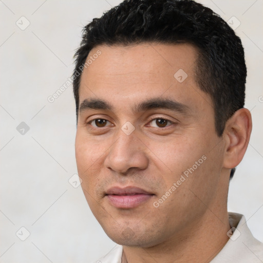 Joyful white young-adult male with short  black hair and brown eyes