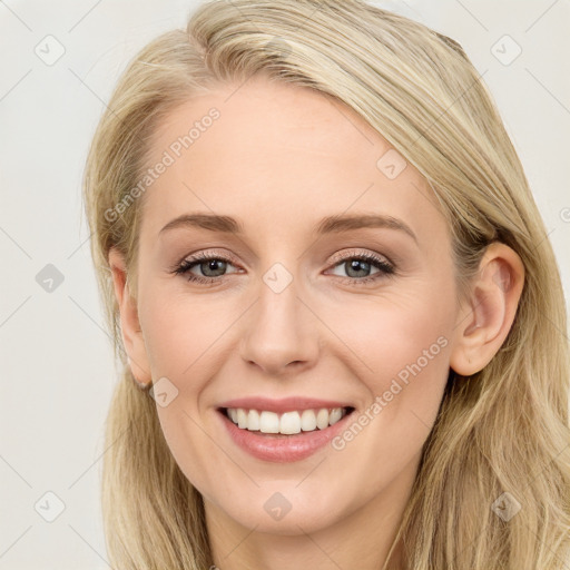 Joyful white young-adult female with long  brown hair and blue eyes