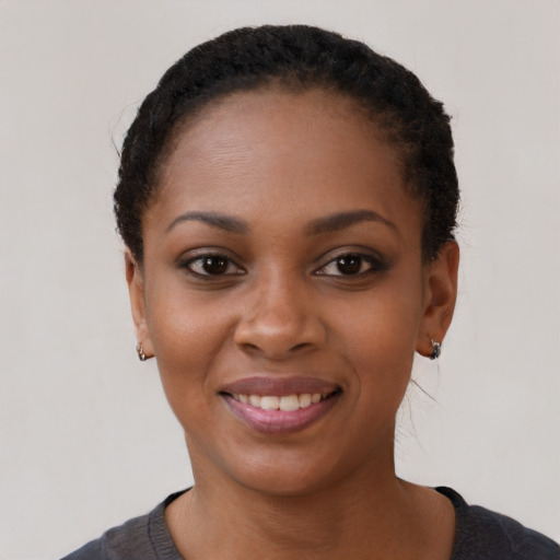 Joyful black young-adult female with short  black hair and brown eyes