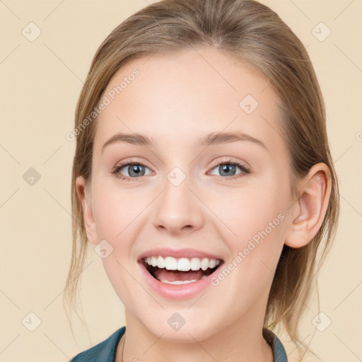 Joyful white young-adult female with medium  brown hair and blue eyes