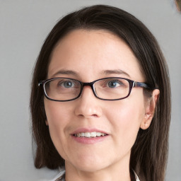 Joyful white young-adult female with medium  brown hair and blue eyes