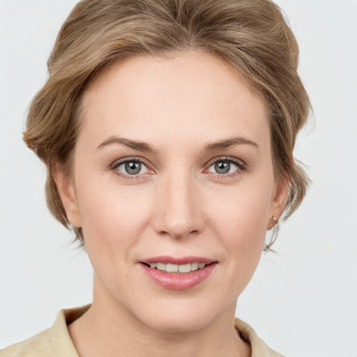 Joyful white young-adult female with medium  brown hair and blue eyes