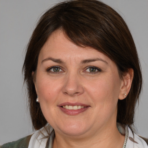 Joyful white adult female with medium  brown hair and brown eyes