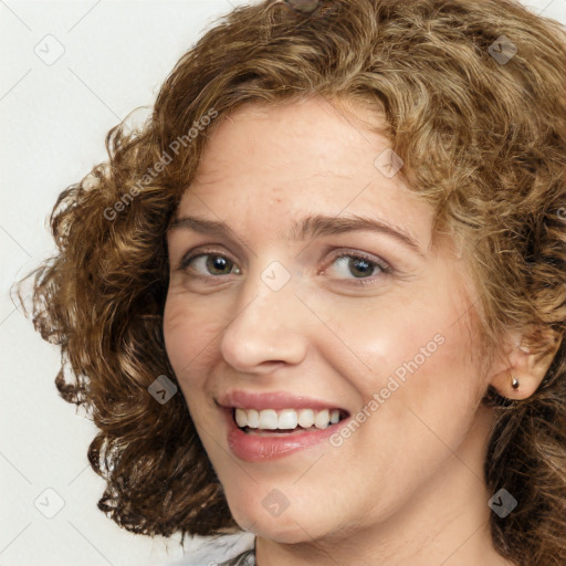 Joyful white young-adult female with medium  brown hair and green eyes