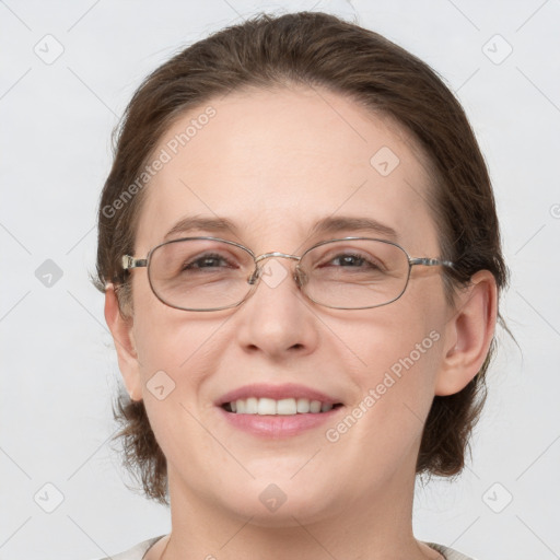 Joyful white adult female with medium  brown hair and grey eyes